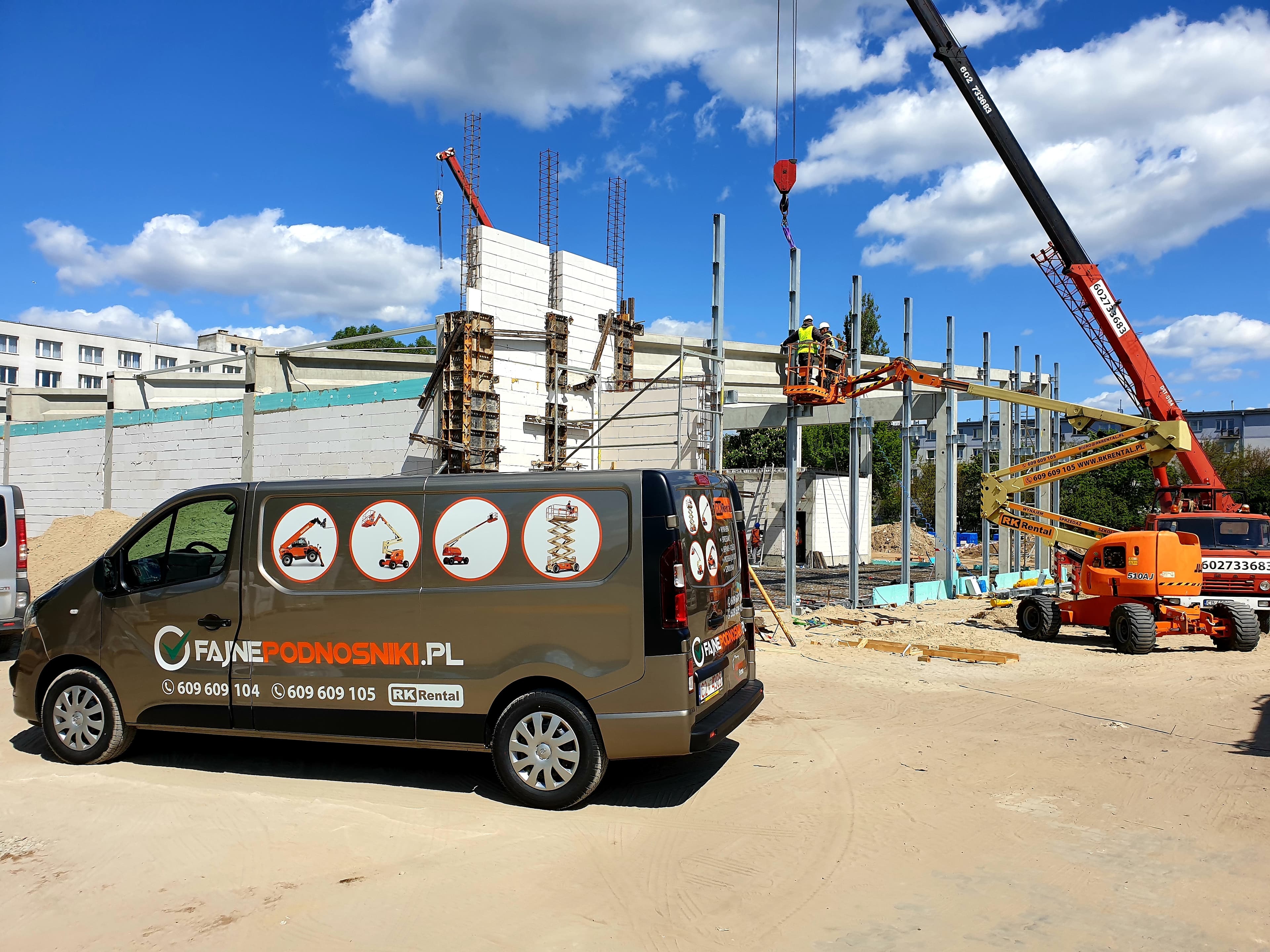 RK Rental mobile service: maintenance inspection of a rented JLG 510AJ diesel articulating boom lift (18 m, 4×4) on a hall construction site in Włocławek