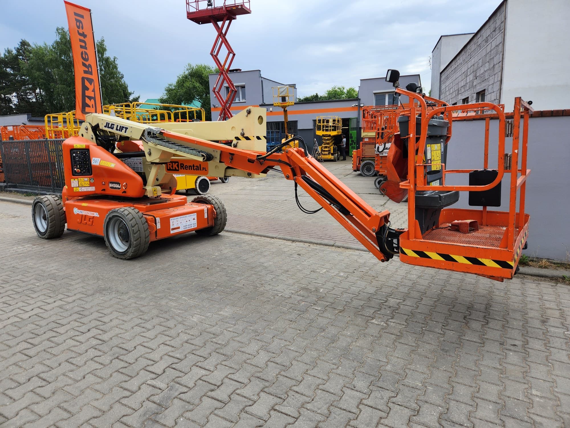 Rented JLG M450AJ electric articulating boom lift (16 m, hybrid) from RK Rental in the base yard in Brzoza before delivery to a customer in Płock
