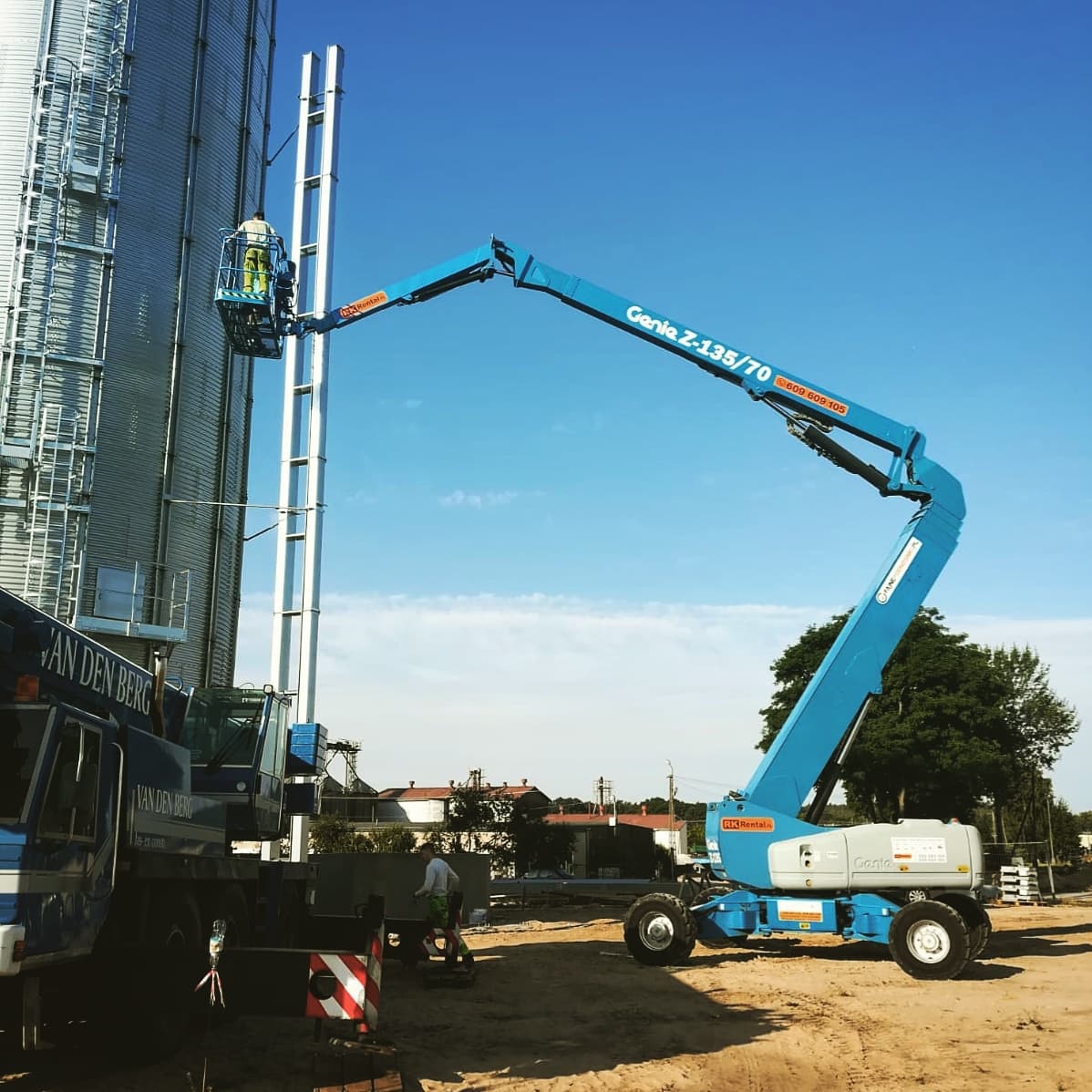 Rented Genie Z-135/70 articulating boom lift (43 m, 4×4) from RK Rental at grain elevators near Inowrocław