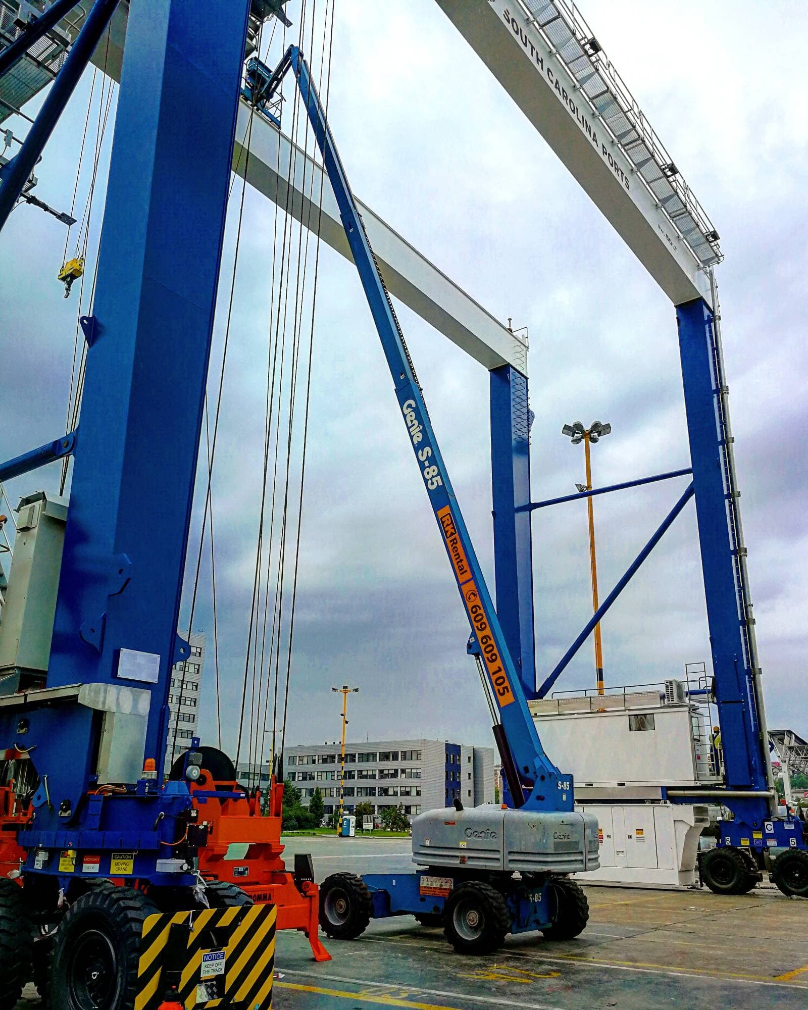 Genie S-85 4x4 telescopic boom lift from RK Rental during maintenance of gantry cranes at the container port in Gdynia